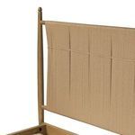 Close-up on left side top corner of woven paper cord headboard with natural wooden spindle leg
