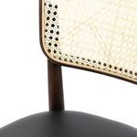 Detail of curved dark wood frame around natural cane backrest on Court Dining Chair