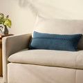 Harvey Blue Pillow styled on beige sofa with soft natural light and vase on side table