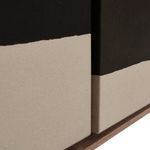 Close-up showing intersection of two canvases with high contrast black and beige paint