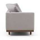 Straight on view of chaise left side showing full armrest shape and cushion layout