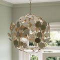 Silver orb chandelier in bright entrance area showing shiny metal discs against window background