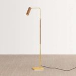 Narragansett floor lamp with aged brass frame, rattan-wrapped midsection and cylindrical rattan shade on elongated swing arm