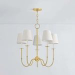 Amina Chandelier with aged brass finish, five slender J-arms, white linen shades, and traditional Victorian metalwork details