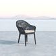 Single Milano Dining Chair isolated on concrete floor with distant mountains and sky backdrop