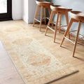 Runner-size Rosette Ivory / Terracotta rug under tall wooden bar stools on light hardwood floor