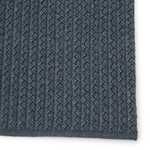 Detailed close-up of braided pattern with thick tight weave and dark blue-gray color