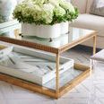 Side view of Madison Bench next to gold-framed glass coffee table on patterned rug