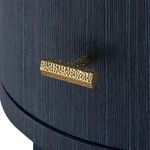 Detail of hammered gold drawer handle on selvage blue textured drawer front