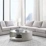 Lucy Modular Sectional arranged in a bright room with large windows, showing a curved sectional layout with soft textured ...