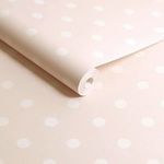 Rolled wallpaper displaying smooth matte finish and pink cream polka dot pattern