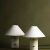 Two Bond Patina Brass lamps side by side from front angle on olive green background
