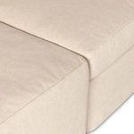 Lower close-up of ottoman and sectional base showing full slipcover coverage