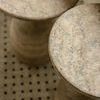 top-down close detail of textured table tops in bathroom scene on tiled floor
