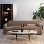 Finch Sofa front view in a bright space with decorative pillows and minimalist coffee table