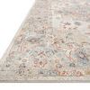 Low angle close-up showing edge and pile texture of ivory and multicolor traditional rug