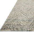 Angled side view highlighting rug thickness and layered geometric texture with ivory and moss tones