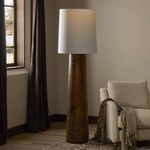 Daxton floor lamp next to beige armchair with throw in neutral living room setting near window