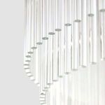 Close-up angle showing layered clear glass rods with rounded ends on Kaela chandelier