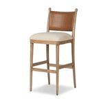Three-quarter angled view showing the tapered legs and crossbars of the bar stool
