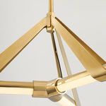 Close-up of the aged brass frame showing triangular support arms and central connecting joint