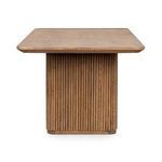 End view showing rounded rectangular tabletop shape and vertical fluted wood pattern on leg