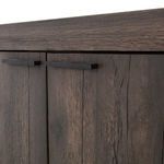 Close-up detail of iron handles and adjacent oak wood grain on sideboard doors