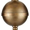 Repeat close-up of textured spherical brass accent on lamp pole with thin horizontal band