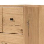 Close-up of black metal knob on light oak drawer front with resin accent lines