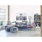 Living room context with Petro Coffee Table styled alongside grey sectional sofa and purple chair