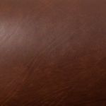 Close-up texture of mahogany top-grain leather upholstery surface