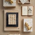 Styled overhead view of the boxes with surrounding décor including books and gold fish figurines