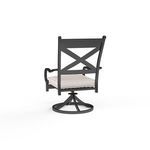 Rear view highlighting the chair’s crisscross backrest and round swivel base in dark finish
