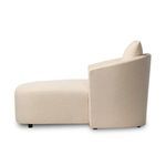 Side profile of the lounge highlighting its rounded back and thick cushioned seat