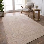 Josephine Medallion rug styled in a bright room with wooden floor, armchair, side table, and greenery