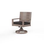 Laguna Swivel Dining Chair in hand-brushed aluminum finish mimicking driftwood with black cushion on round swivel base