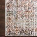 Corner portion of Adrian Sunset Charcoal rug on dark hardwood floor highlighting pattern and border details