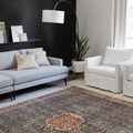 Layla rug styled in modern living room with gray sofa and white armchair, showing scale and versatility