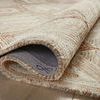 Varena rug partially rolled to reveal dense wool fibers and underside texture