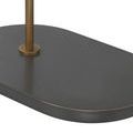Dark oval base close-up showing subtle brushed metal texture and rounded edges