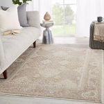Rug styled in bright living room setting with sofa, side tables, and floor-to-ceiling window