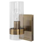 Right angle view of sconce with bulb off highlighting clear glass and brass finish