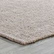 Angled view of rug on light wood floor showing edge and low-profile thickness