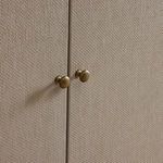 Fiona Bar Cabinet styled with glassware and decorative gold bowl on top in room setting