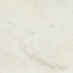 Close-up of white marble's smooth surface and subtle gray veining on Calla Bookshelf Lamp base
