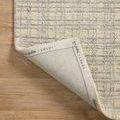 Polly Antique / Mist Rug corner flipped to reveal branded underside on hardwood floor