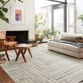Yeshaia rug styled in bright modern living room with natural wood furniture and large windows