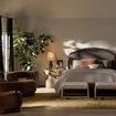 Eleanor Accent Stool styled in a bedroom setting at the foot of a bed with soft lighting