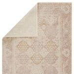 Top corner of the rug folded back to reveal solid light gray reverse side