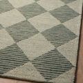 Tightly framed view of Francis Spa Granite Rug corner showing finished edging and wool loop texture